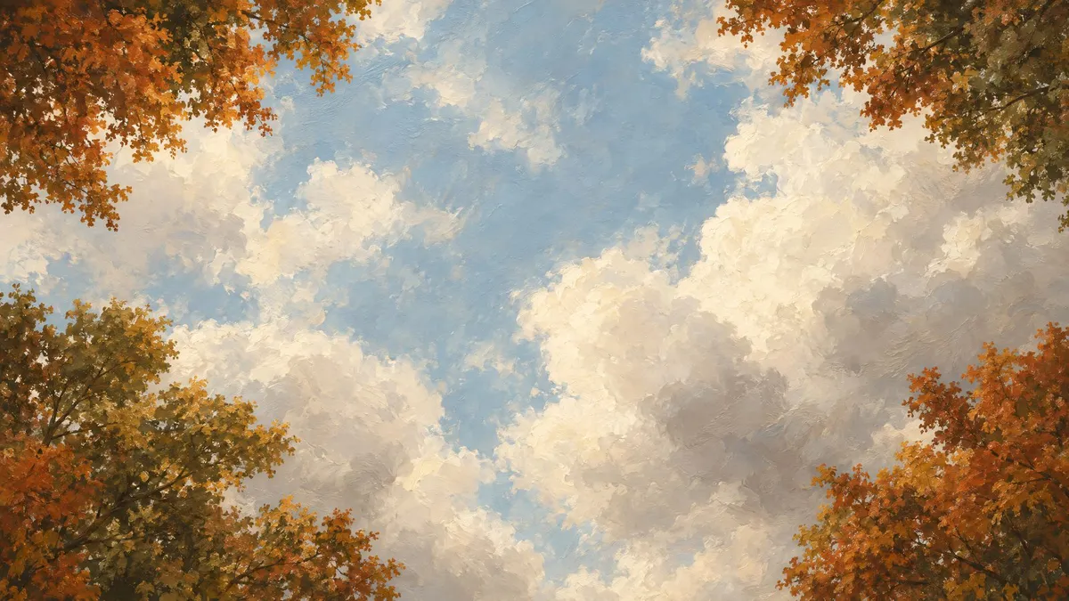 Billowing clouds in a pale blue sky, seen from below and framed by rust and olive autumn treetops