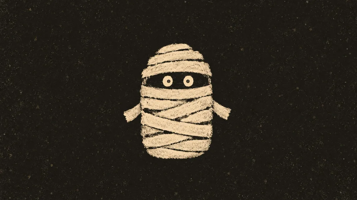 Cream chalk drawing of a small blocky mummy with round eyes and stubby bandage arms centered on a dark charcoal ground